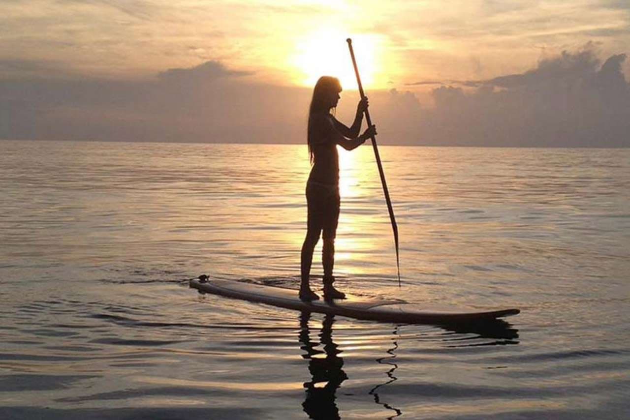 Paddleboarding on calm water off Sporting Club Beach